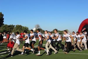 Sea King football players run out in front of cameras during the live segment.