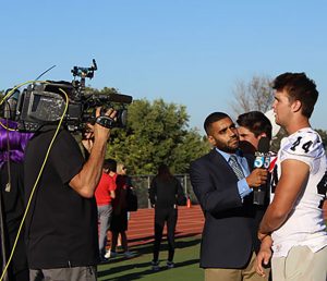 KTLA reporter Avi Bernard interviews football players Tre Gonzalez and Shane Irwin.