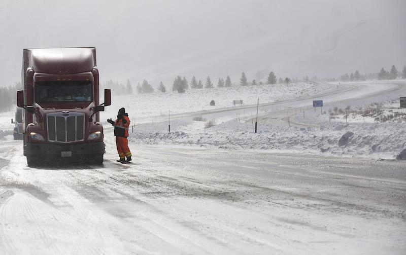 Transportation worker Mark Reistetter gives a Reno, Nev.-bound truck driver his options at a checkpoint closing all northbound traffic at US 395 and state route 203 near Mammoth Lakes, Calif., on Tuesday, Jan. 10, 2017. (Brian van der Brug/Los Angeles Times/TNS)