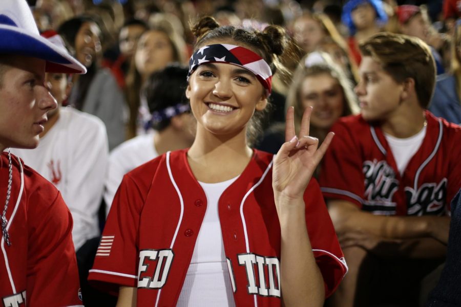 Nicole Halverson helps to lead the Red Tide section at a football game.