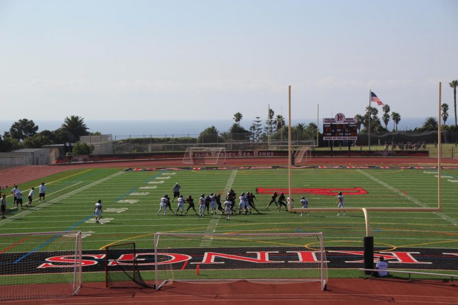 Football players competiting on new turf