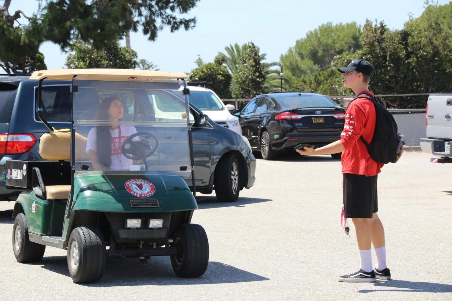 Junior Alden Shive pleads his case to go to his car to security guard Kelsey Gonzalez.