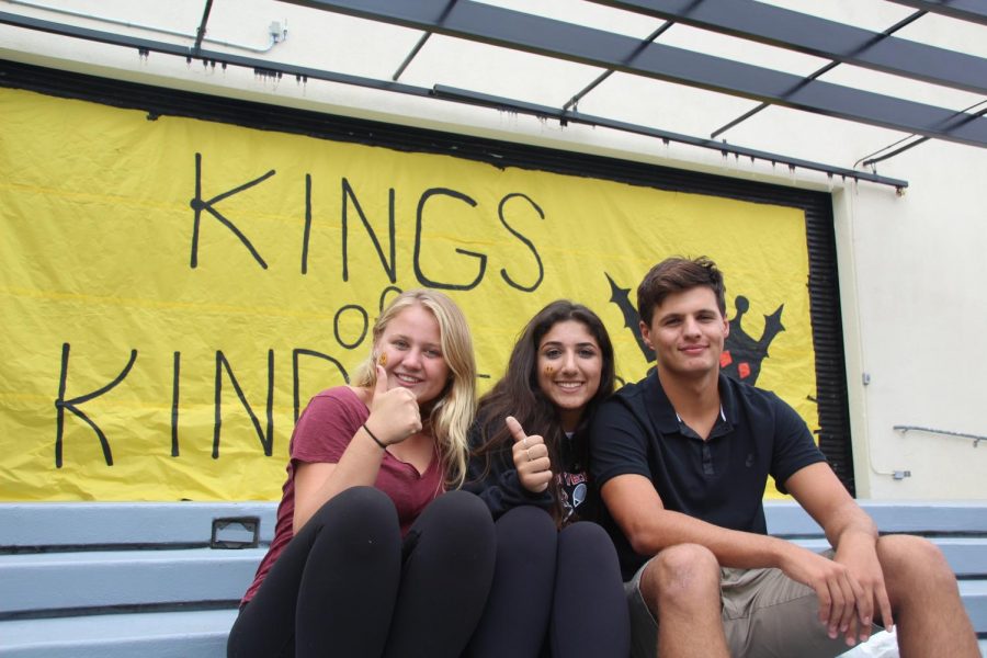 Three students pose amidst Yellow Ribbon Week festivities. (Photo by McKinley Pieper)