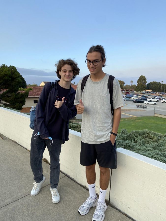 Askari (left) and Holub (right) pose in front of their new school
(Photo courtesy of Heidi Hiatt)